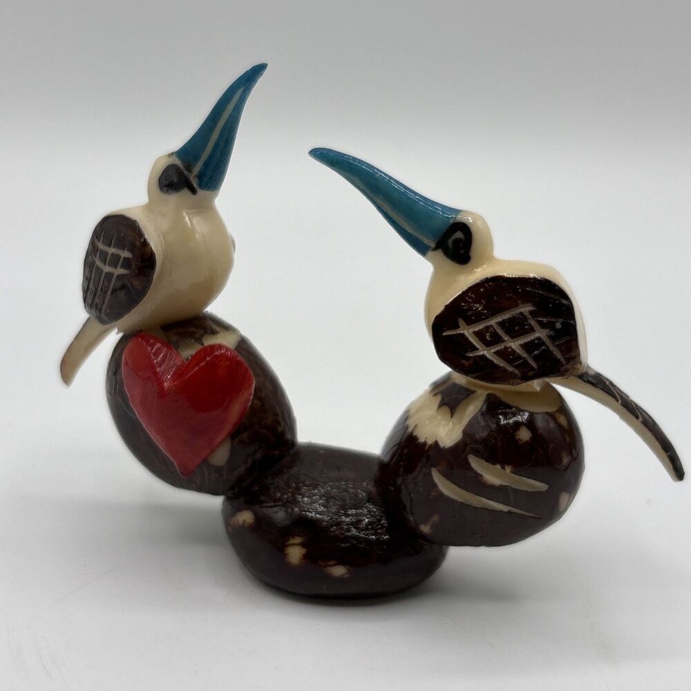 handcrafted tagua nut figurine depicting two birds
